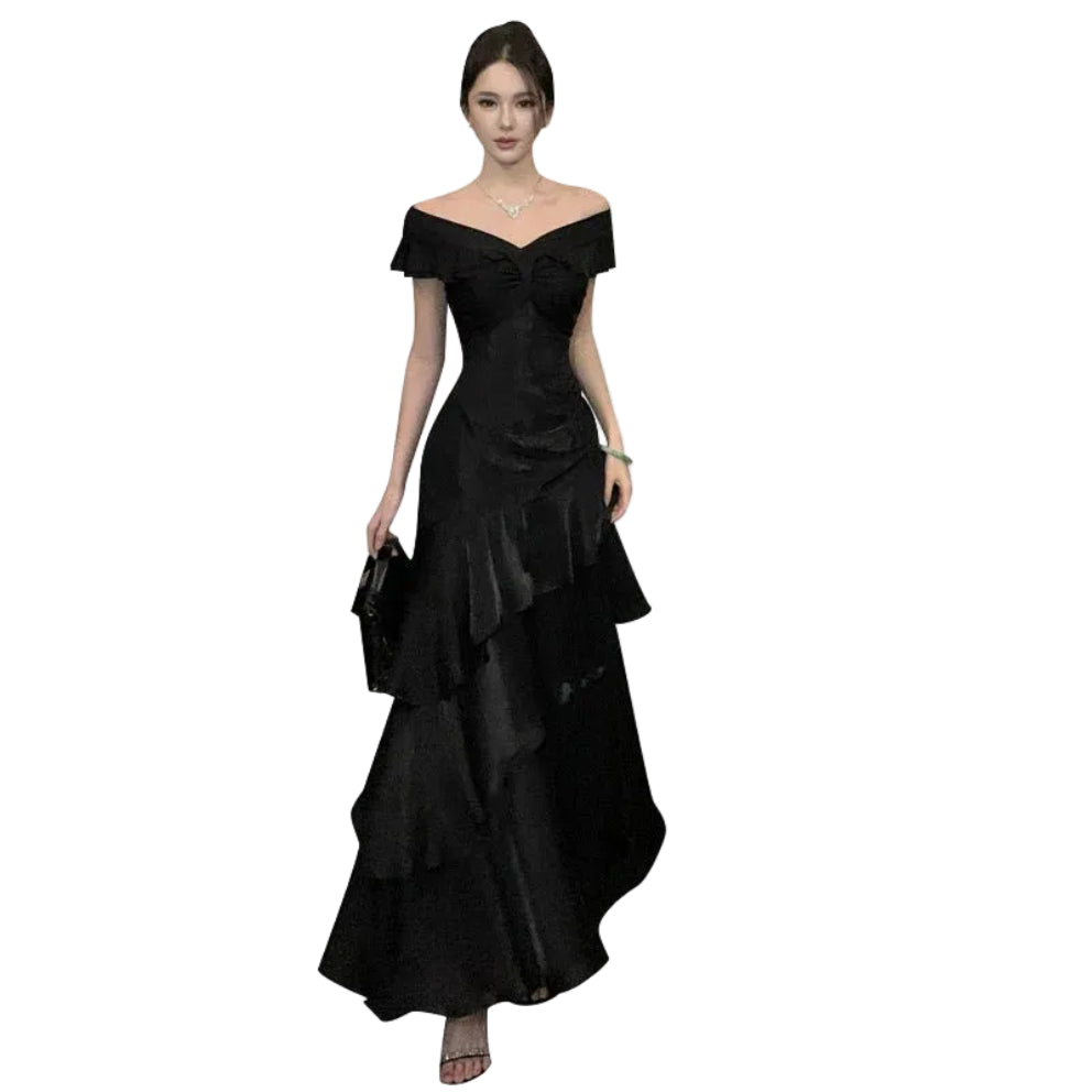 Woman wearing a black off-shoulder dress on a white background