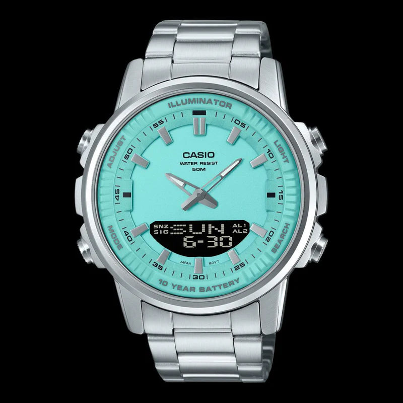 Casio watch with green face and silver metal strap on black background